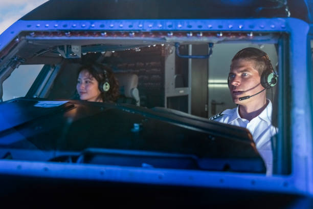 istock Instructor and a trainee pilot sitting the cockpit of a flight simulator 1432221773