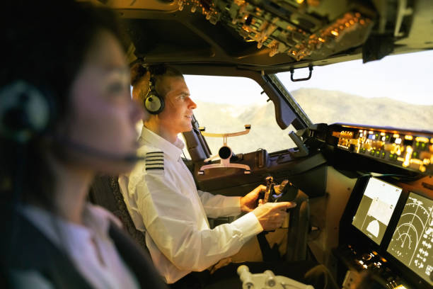 istock Pilot with woman co-pilot flying a commercial jet airplane 1432221861