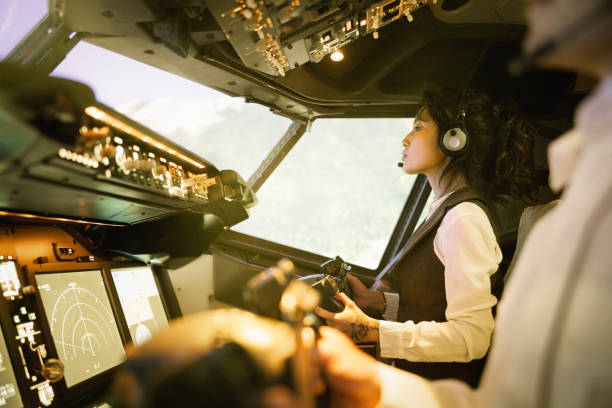 istock Woman pilot with a co-pilot flying a commercial jet airplane 1432221865