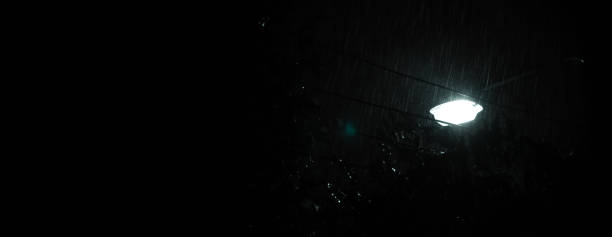 istock Raining Night and light. Rain Drops Falling in night at Bangkok Thailand in August raining season. Rain speedy at night. Shower rainfall. Rain falling. Rain Drop Street light. Weather forcast concept. 1432222514