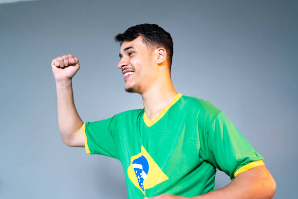 istock Brazilian young man fan celebrating on green uniform 1432222852