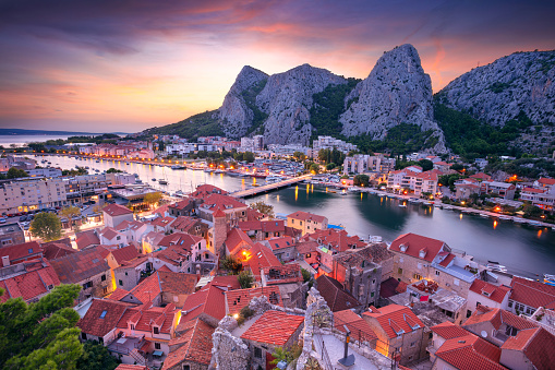 Cityscape image of beautiful coastal town Omis, Dalmatia, Croatia at summer sunset.