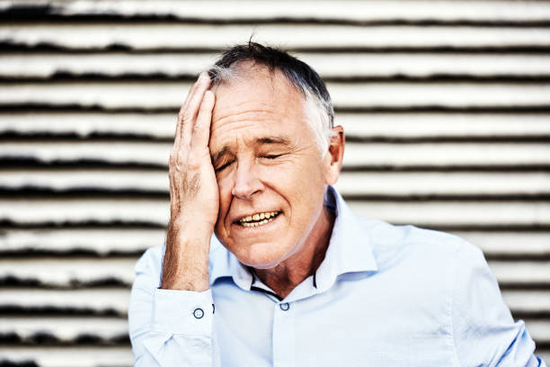 istock Handsome middle-aged man facepalms, clutching his head about a problem, embarrassment or regret 1432224270