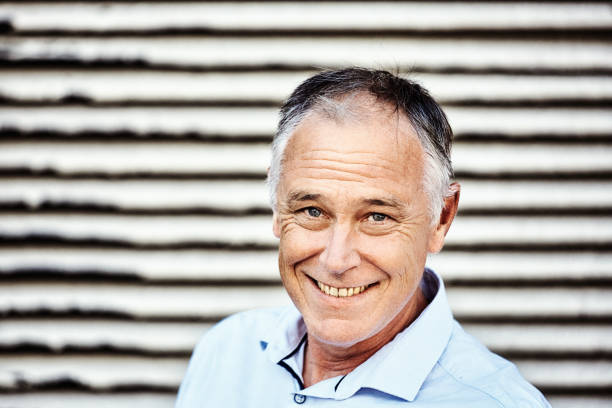 istock Handsome middle-aged man smiles and looks at the camera 1432224539