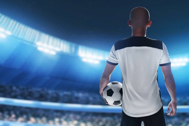 istock Soccer player holding ball in the stadium 1432225972