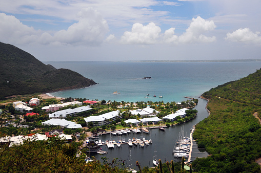 Anse Marcel, Collectivity of Saint Martin / Collectivité de Saint-Martin, French Caribbean: sheltered cove with a sandy beach surrounded by rolling hills, hosting luxury hotels and the Marina Port de Lonvilliers - seen from the mountains.