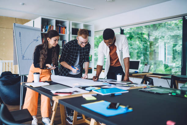 istock Multiethnic coworkers drawing draft together 1432227272