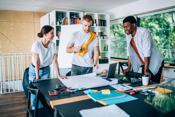 istock Busy man working on model of project with colleagues 1432227305