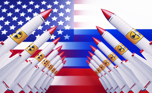 Nuclear missiles before American and Russian flags. Horizontal composition with copy space.  Nuclear war concept.