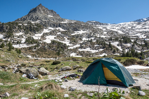 Tent set up in a flat area in the mountains, will camping