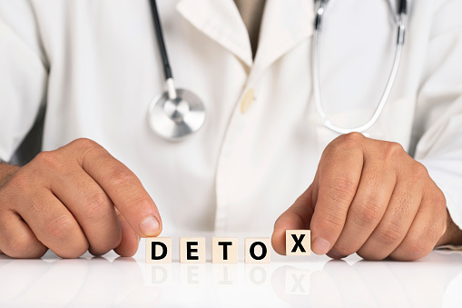 Doctor and cubes with text DETOX
