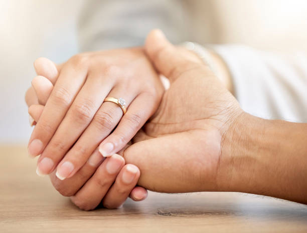 istock Couple engagement with hands holding and presenting a diamond ring for a save the date announcement. Love, hope and trust between a man and woman with jewelry ready for a future wedding celebration 1432230051