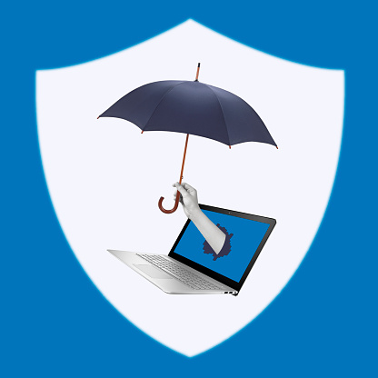 Creative collage of hand holding umbrella over laptop. Computer protection from viruses and hacker attacks.