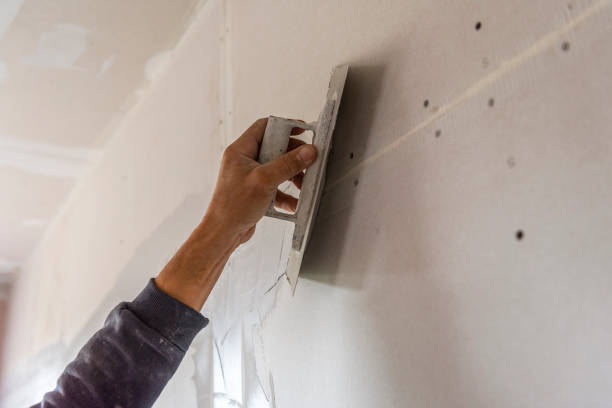istock Old manual worker with wall plastering tools renovating house. 1432239692