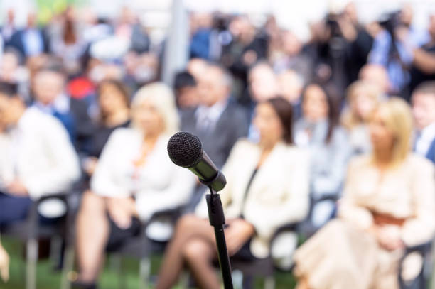 istock Business conference event or corporate presentation, microphone in the focus, blurred audience in the background 1432242307