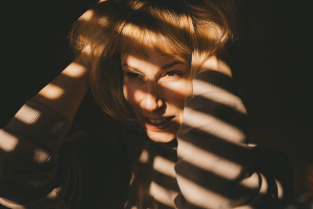istock Woman in sunlight at the window 1432244830