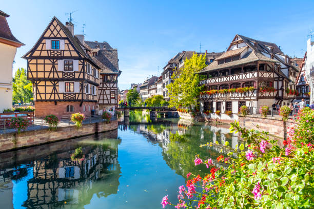 pintorescos edificios de entramado de madera de tiendas, casas y cafés en la zona del canal petite france a lo largo del río ill en la histórica ciudad de estrasburgo, en la región de alsacia de francia. la maison des tanneurs (casa de los curtidores)  - alsacia fotografías e imágenes de stock