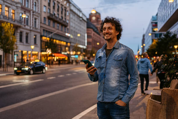 istock Young Man Using Phone In The City At Night 1432248146