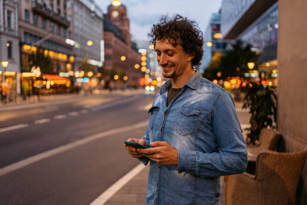 istock Young Man Using Phone In The City At Night 1432248603