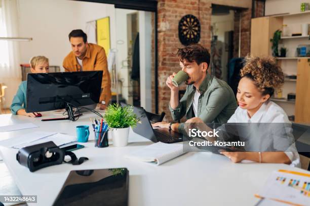 A Diverse Group Of Programmers Learn Coding Using A Laptop Computer And ...