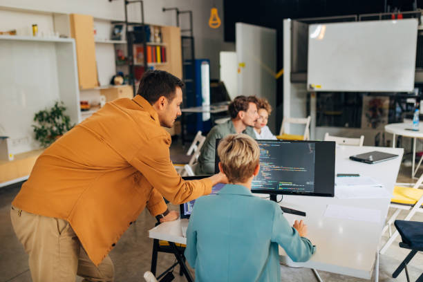 istock A small group of people sit in an office and learn how to code a program. They work in pairs 1432248737
