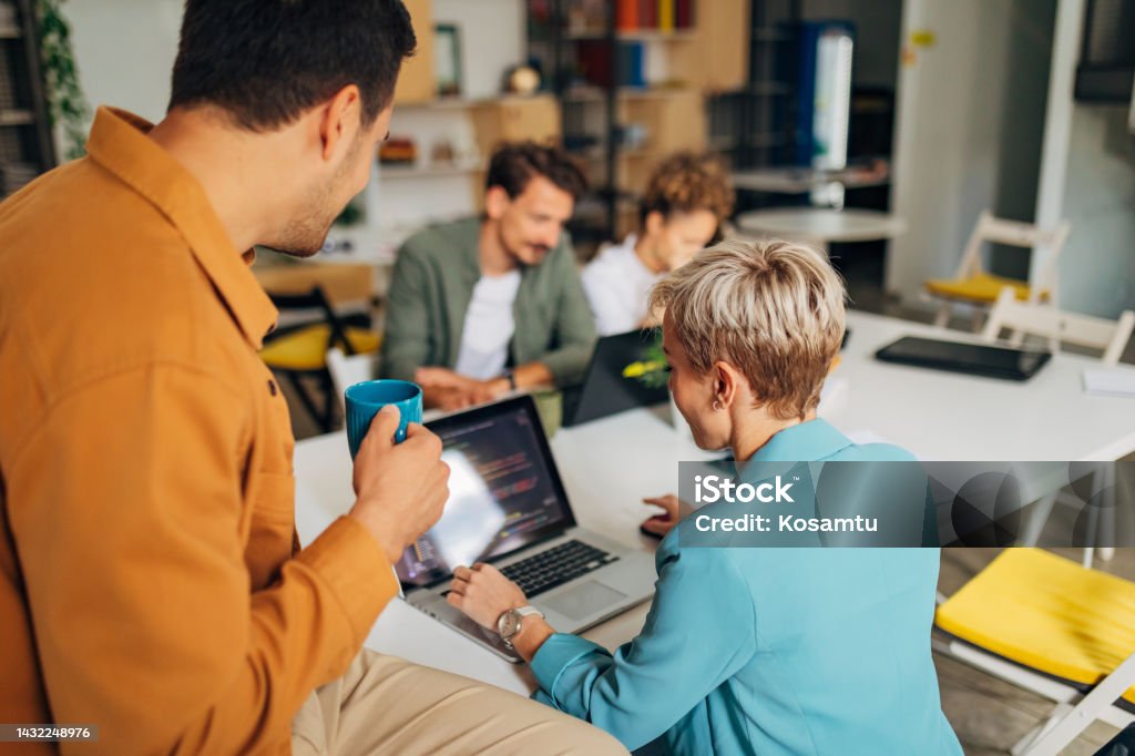 A Group Of People Learn Coding Techniques While Being Supervised By A ...
