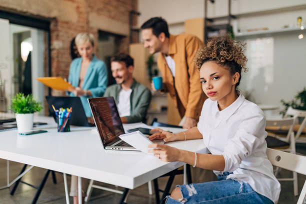istock Portrait of a gorgeous multiracial woman learning coding techniques with a group of developers 1432250300