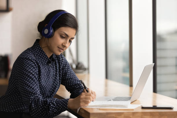 istock Attentive hindu woman trainee hearing lecture course online take notes 1432253977