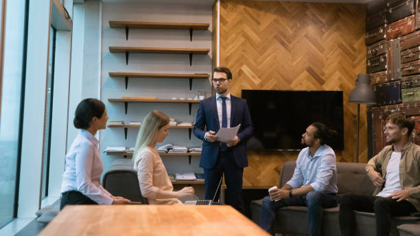 istock Interested group of colleagues listen to speaker presenting new idea 1432254035