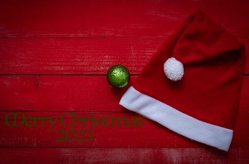 Santa Claus hat on wooden background, holiday Christmas concept