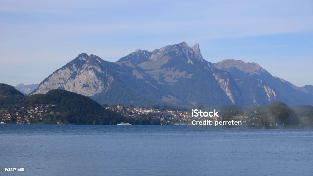 Spiez, village at the shore of Lake Thun, Switzerland. Village Spiez and Mount Stockhorn, Switzerland. Blue Stock Photo