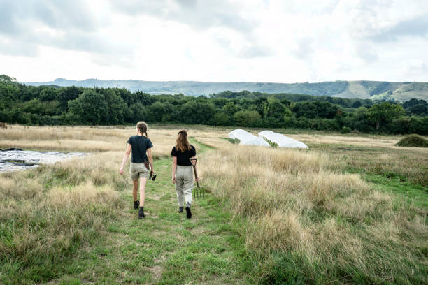 istock Young farmers walking with tools toward market garden 1432272110