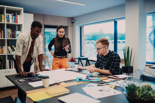 istock Young colleagues looking at drawing in office 1432273225