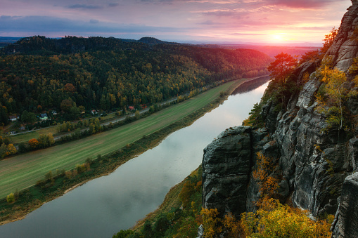 A wonderful sunset over the river Elbe that breaks through the mountain range in a steep and narrow valley. Saxon Switzerland National Park. Germany. Saxony.