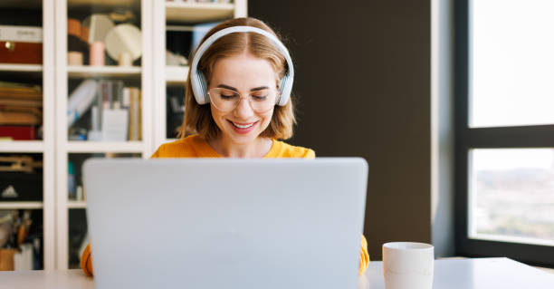 istock Happy young female having video call while working remotely or studying online on laptop from home 1432274301