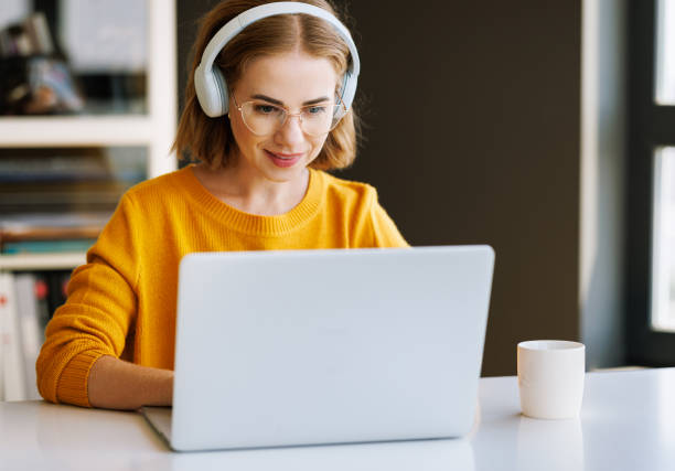 istock Happy young female having video call while working remotely or studying online on laptop from home 1432276890