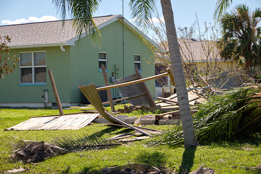 Home yard with scattered debris after hurricane Ian in Florida. Consequences of natural disaster.