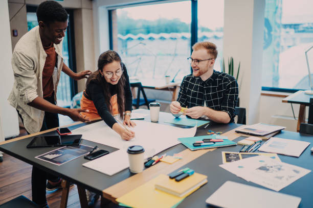 istock Young colleagues drawing up plans in office 1432276977