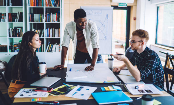 istock Smart casual engineers collaborating on blueprint sketch brainstorming on productive analyzing, multicultural male and female colleagues briefing during education learning in coworking space 1432277052