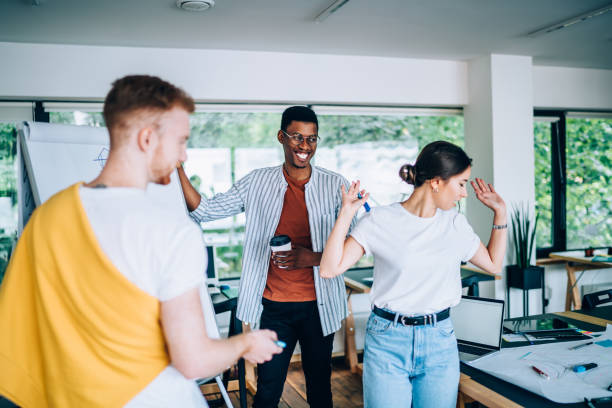 istock Black playful male discussing project with coworkers 1432277176