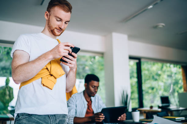 istock Multiracial colleagues watching tablet and cellphone in office 1432277211