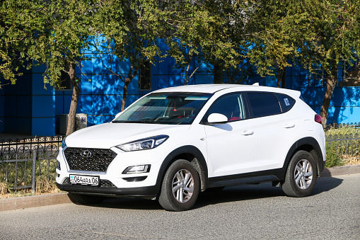Atyrau, Kazakhstan - October 4, 2022: White crossover Hyundai Tucson in the city street.