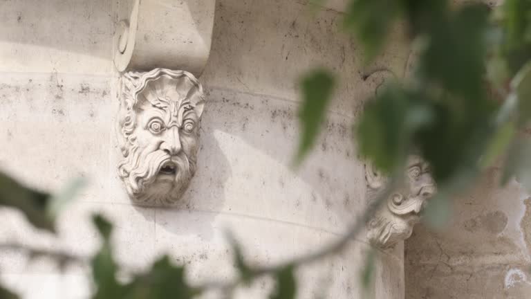 Close-up of a stone mask on Pont Neuf