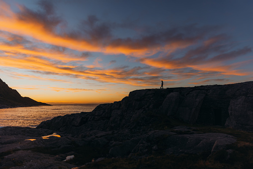 Silhouette of a person looking at the Gulf of Finland during the sunset.