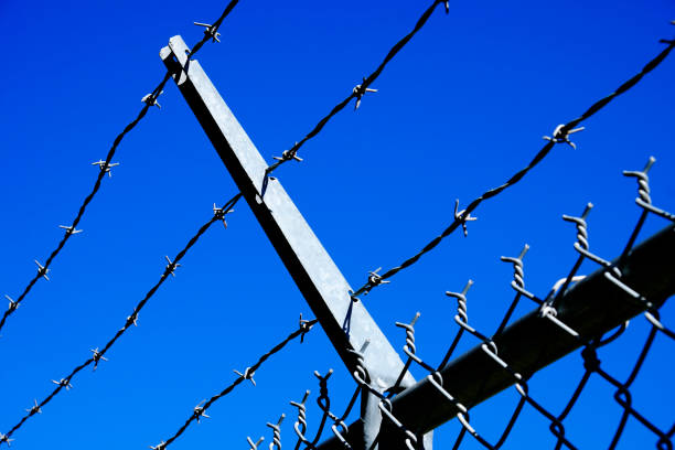 istock Barbed Wire Fence for Security Extended Arms 1432279479
