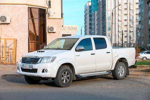 Atyrau, Kazakhstan - October 4, 2022: White pickup truck Toyota Hilux in the city street.
