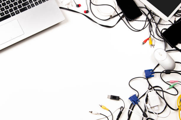 istock Old laptop computer, digital tablet, mobile phones, cable, cords, used electronic gadgets devices on white table. Top view. Planned obsolescence, e-waste, electronic waste for recycling concept 1432281287