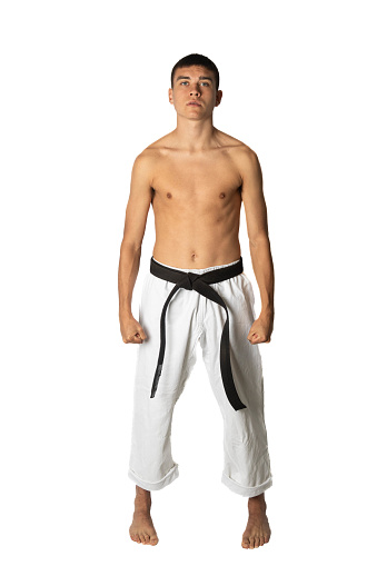 A shirtless 19 year old teenage karate black belt posing