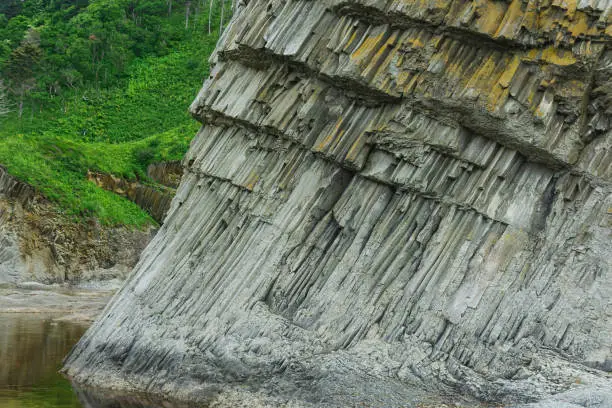 foot of a coastal cliff composed of columnar basalt, on the island of Kunashir