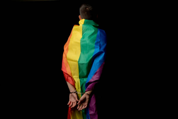 istock Arrested 19 Year Old Teenage Boy wrapped in A Pride Flag 1432287263